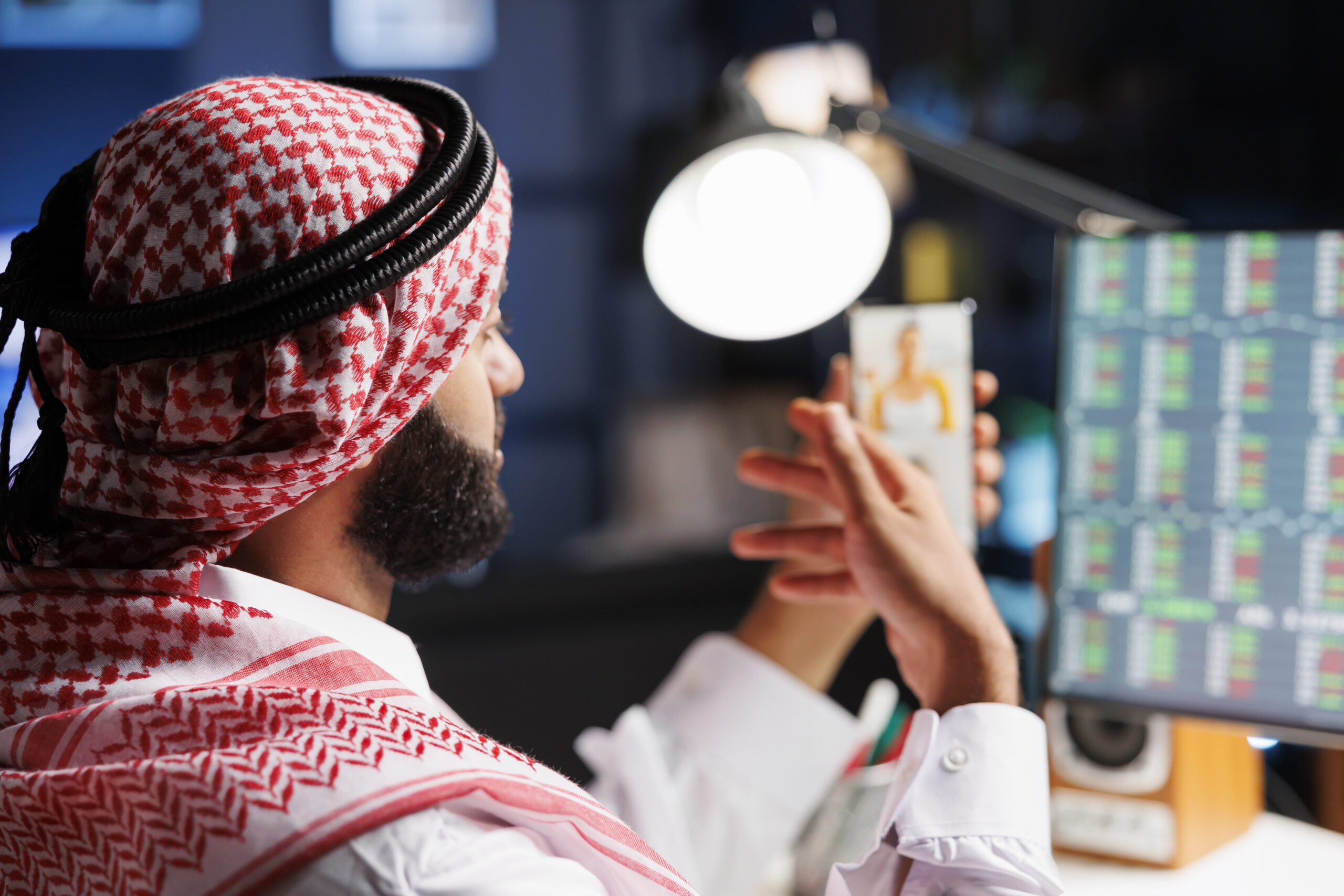 Muslim man video conferencing with phone
